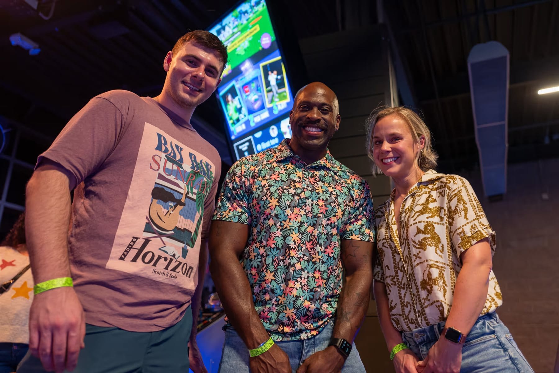 Game developers smiling together at an arcade event